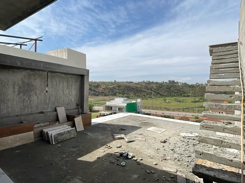 Rooftop slab during construction with block work and tiling materials